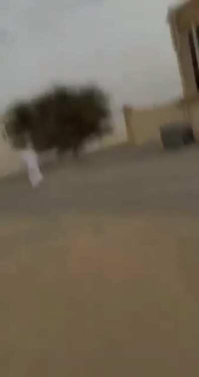 Some Arab blokes messing around with their friend