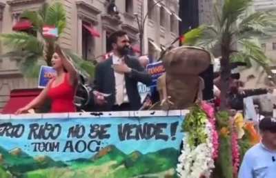 AOC and NYC mayoral candidate Zohran Mamdani dancing on a float