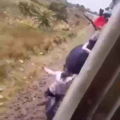Attempt to jump off train results in swinging under it and…