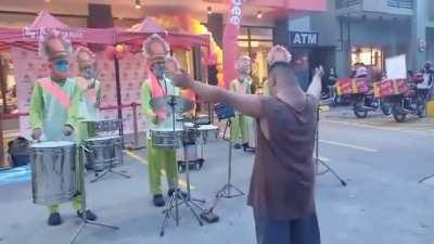 A child with down syndrome conducts an entire marching band.
