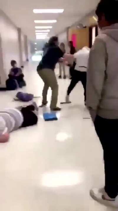 Women falls HARD trying to stop a fight