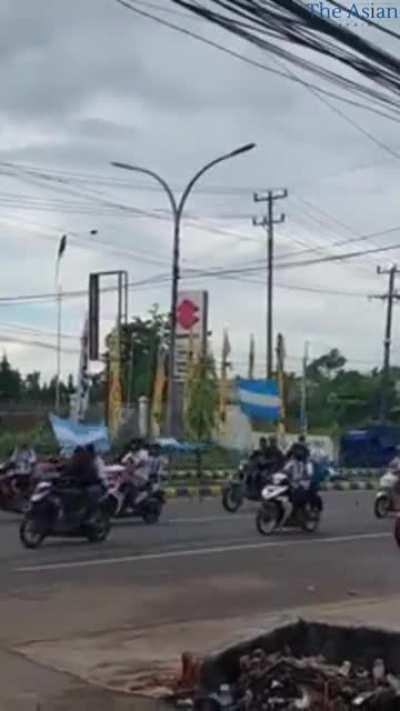 People come out to celebrate Argentina's victory against the Netherlands, in the city of Sorong, Indonesia