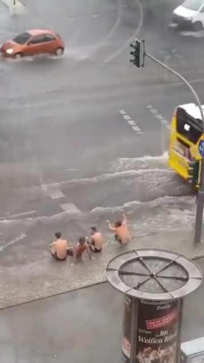 More guys enjoying flood puddles.
