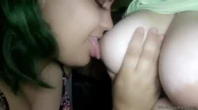 Sucking on her friend's titty