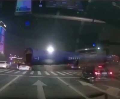 Car gets dragged along by a very large pipe