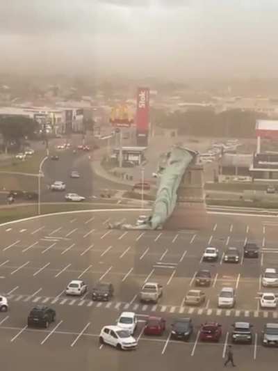 Statue of Liberty replica falling after severe weather.