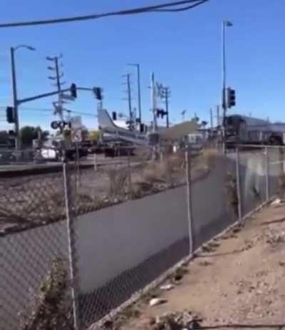 Crashed plane becomes unexpected participant in a train crash (pilot was pulled to safety just in time)