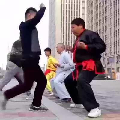 Chinese guys encourage ball destruction as part of their daily workout