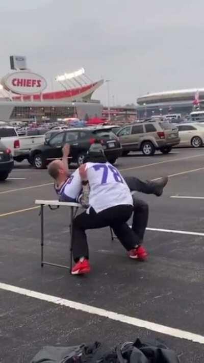 Dude slams guy into a folding table for fun and dude falls on the ground