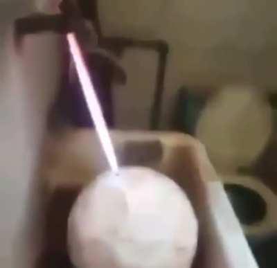 Filling a football with gas and lightning the escaping gas.