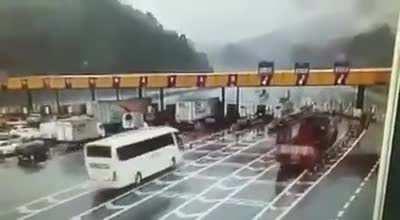 Truck takes out toll booth.