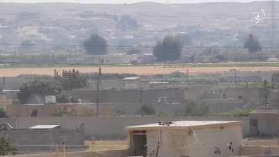 A ISIS fighter with an amputated leg fires his PKM at SDF positions in Raqqa, Syria.