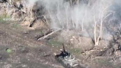 RU pov: Footage of two RU tanks assaulting an UA position. UA soldiers can be seen throwing grenades/explosive towards RU tank from a distance of 5-10 meters. It then shows the UA soldiers fleeing, with one soldier getting hit and wounded.