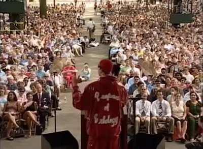 Colin Jost in the background at Ali G's 2004 Harvard commencement address