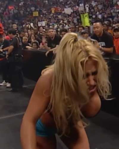 Trish in her bra showing off her massive rack