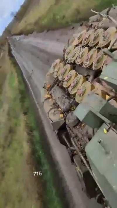 Ru pov Russian soldier rides on BMP with AT mines strapped to it