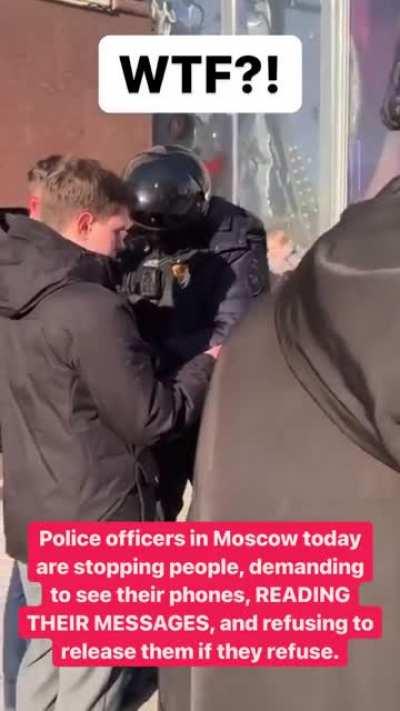 Police officers in Moscow stopping people and checking their phones, reading their messages
