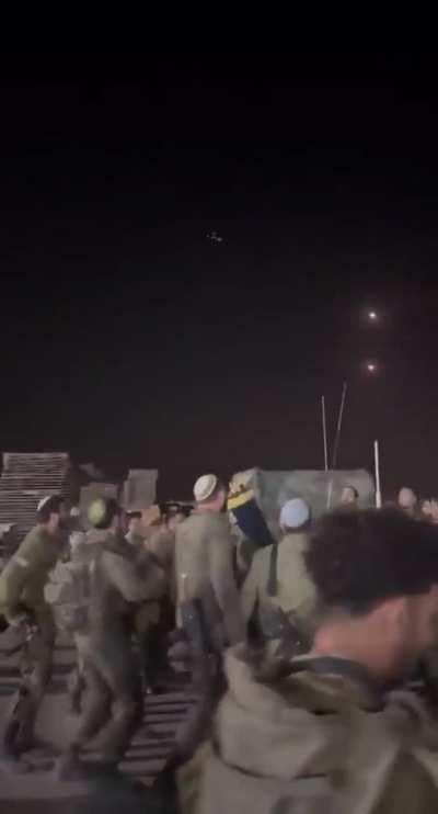 Israeli soldiers singing and dancing as the iron dome intercepts missiles above them
