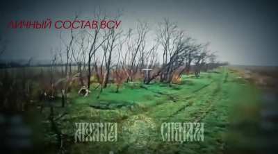 A Ukrainian soldier attempts to throw his rifle at an approaching fiber-optics FPV drone