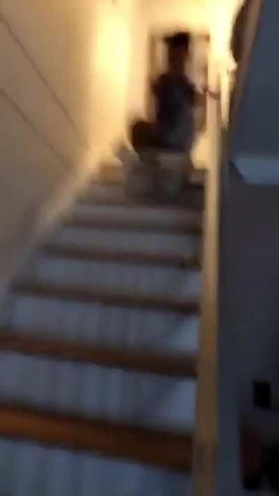 Sliding down wooden stairs in a hamper!
