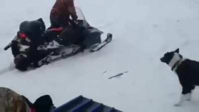 Man gets stuck in snowmobile tracks.