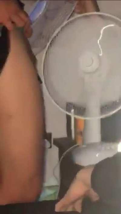 Sticking his testicles into a fan