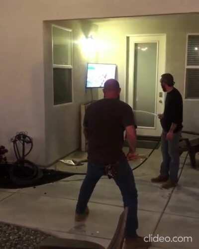 Three grown men try to flush out a pest