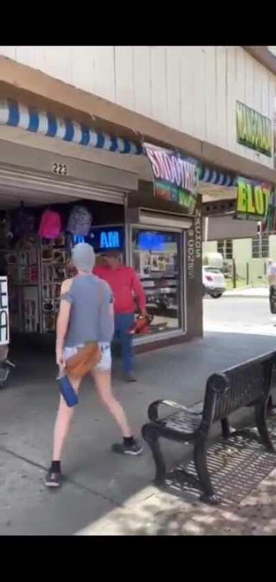 Guy threatening peaceful protestor in downtown McAllen with a chainsaw.