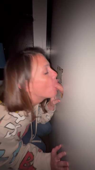 Nerdy milf sucking stranger cock at the Gloryhole
