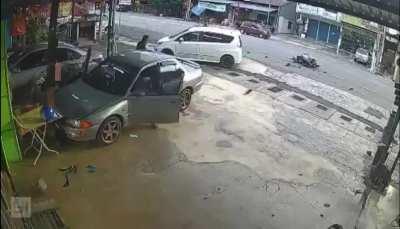 Bike plows in car making u-turn. (Malaysia)