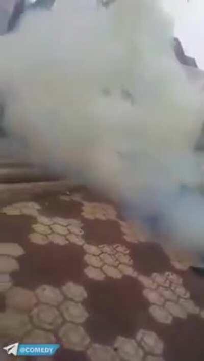 Throws homemade firework into street, hides behind thin pole