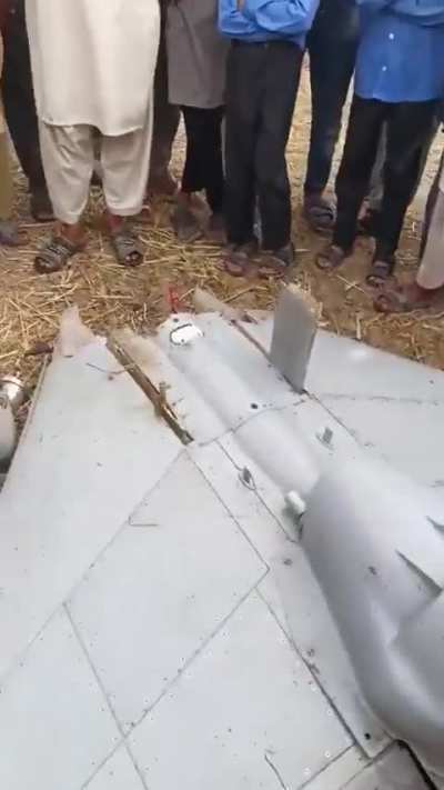 Pakistani Locals discussing to use downed drone's spare parts for his broken down fridge(Looks like a Harop)