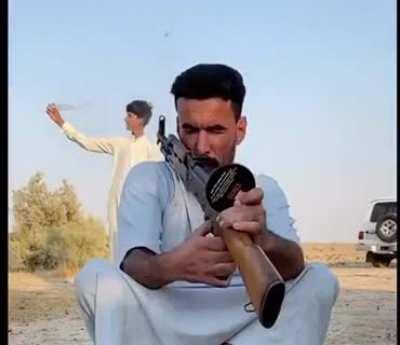 Open a bottle of water by AK47.