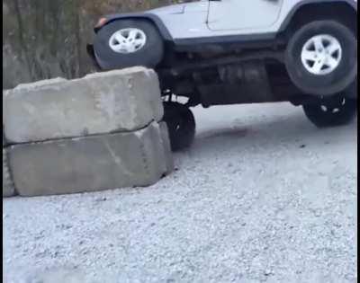 Driving Jeep on Concrete barricade