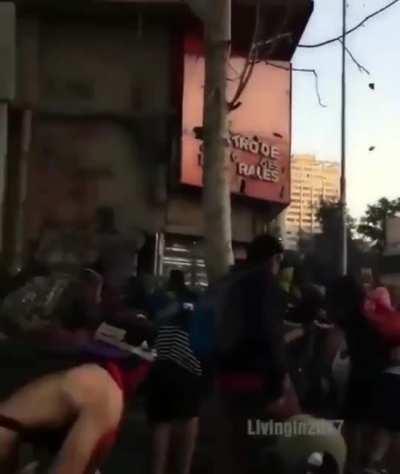 Man with saxophone plays during a protest in Chile
