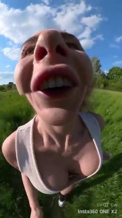 Girl running and biking with a 360 camera in her mouth