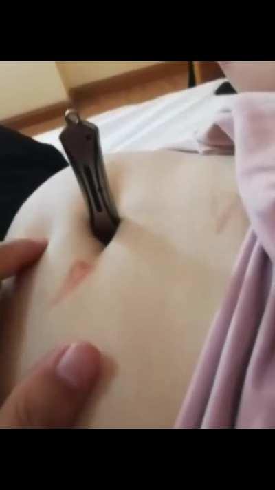 knife inside her navel