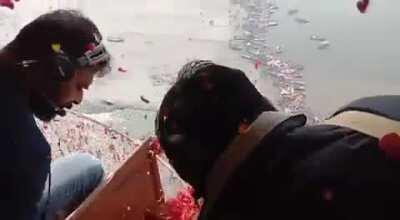 Yogi government showering flowers on devotees through helicopter on the occasion of mauni amavasya