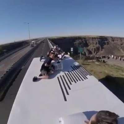 Parachuting off a truck driving over bridge