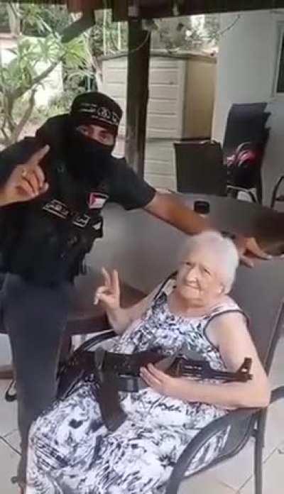 An Israeli old lady just chilling with a Palestinian fighter 😭😂. Earlier today a Palestinian resistance leader said that elderly and children were to remain safe - which is a fantasy compared to the Israeli who deliberately attack them.