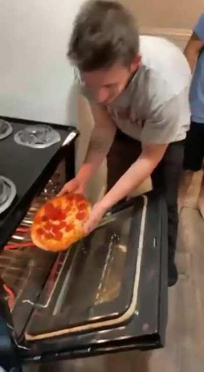 Pulling a pizza out of the oven WCGW