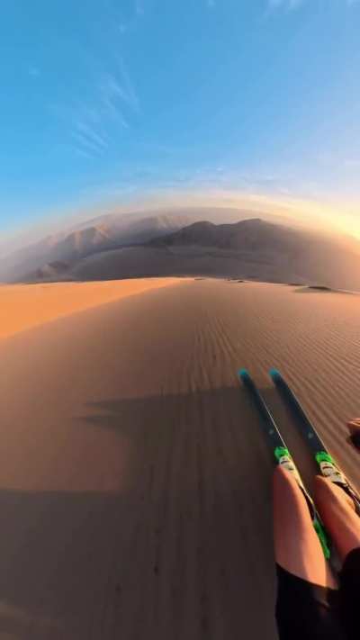 Sand skiing on one of highest dunes in the world in Peru