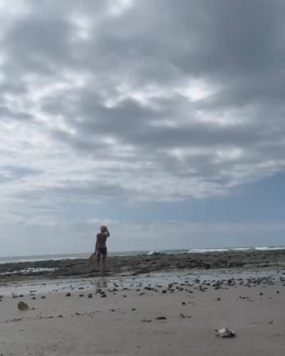 Emily Wickersham (IG) walking on the beach