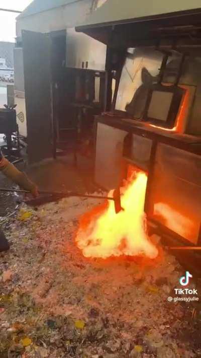 Glassblowers emptying their furnace