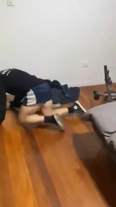 Getting on a bike while it's mounted on the wall.