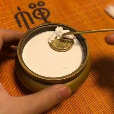 Tamping down the ash before adding incense