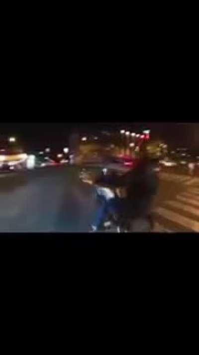 Motorcycle guy tries to do tricks in a busy intersection