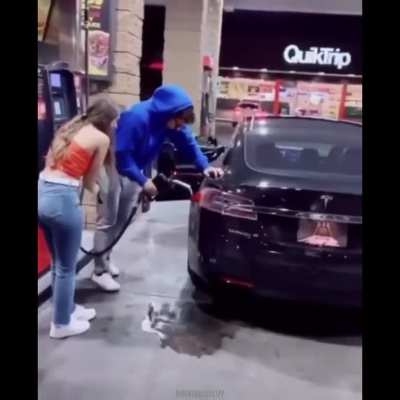 Guy completely high out of his mind tries to fuel his Tesla with gas