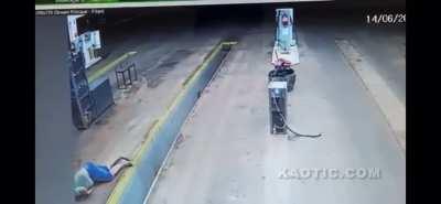 Oblivious motorcycle driver dumps his motorcycle in a pit. He promptly slides on his face.