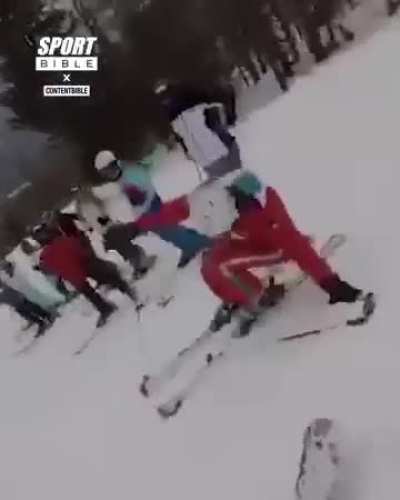 A french Karen/ski instructor goes crazy over a guy who accidentally bumps into her and chases him around hitting him with ski sticks.